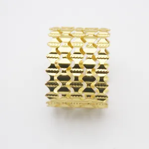 Gold metal napkin ring with elegant hollow wave design, perfect for fine dining setup.