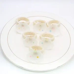 Detailed view of natural white seashell and woven hemp rope napkin rings, table decor.