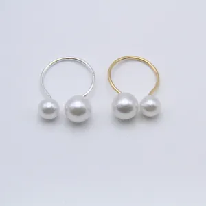 Double pearl open ring set, adjustable U-shaped minimalist gold and silver jewelry detail.