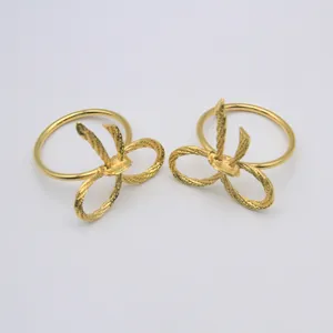 Detailed closeup view of elegant gold bow napkin ring, luxury table decor accessory.
