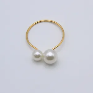 Elegant double pearl napkin ring with gold-tone wire for wedding table decor and hotel use.