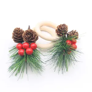 Christmas wooden napkin rings decorated with pine cones and red berries for table decor