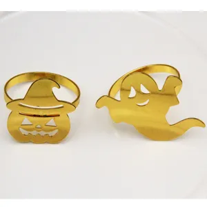 Close-up details of gold Halloween napkin rings featuring cute pumpkin witch and ghost shapes.