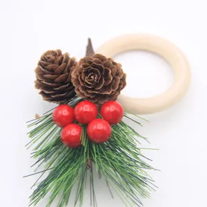 Christmas napkin ring with wooden ring, pine cones, red berries and pine needles for table.