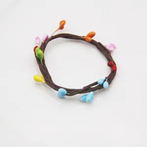 Handcrafted braided vine napkin ring with colorful teardrop berry accents for table decor
