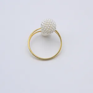 Detailed shot of the elegant pearl bayberry ball napkin ring with double gold spring band.