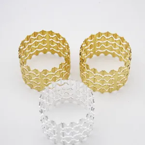 Metal napkin rings set, hollow wave design, gold and silver table decor for hotel dinner party.