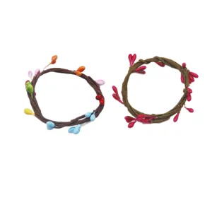 Handcrafted woven vine napkin rings with colorful berry decor for party table settings