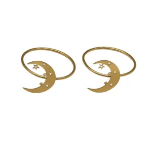Gold metal napkin rings featuring sweet star and moon designs for elegant wedding table decor.