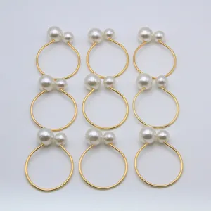 Elegant gold metal napkin rings featuring double faux pearls, set of nine for table decor.