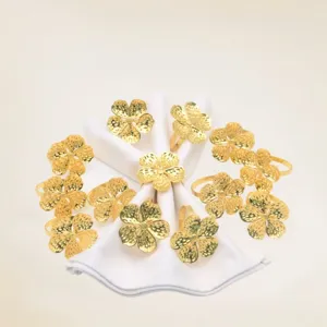 Gold flower napkin rings, elegant alloy napkin holders with hammered texture for table decor.