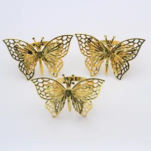 Anelli portatovaglioli a farfalla in metallo dorato, design traforato elegante per tavola e feste.