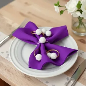 Gold metal napkin rings with white beaded design, elegant table setting accessories for hotels.