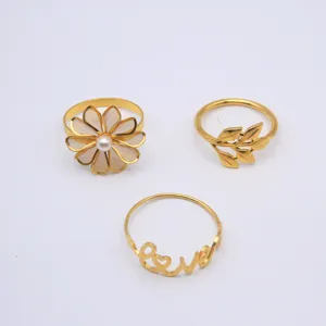 Gold metal napkin rings detail, flower pearl, leaf branch and love letter design for table decor.