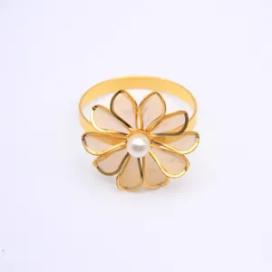 Gold mesh flower napkin ring close-up view, elegant table decor accessory for dining table.