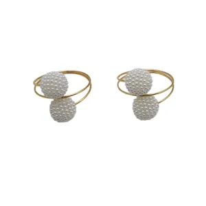 Gold metal napkin rings with double pearl balls, elegant table decor for dining and hotel.
