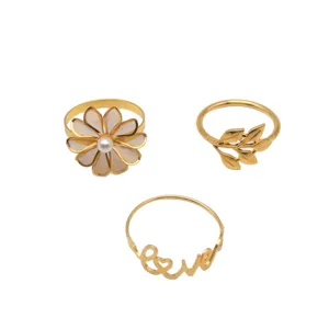 Gold metal napkin rings set of three featuring daisy flower, leaf branch, and love design.