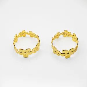 Detailed close-up view of elegant gold metal flower napkin rings for table decor.