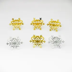 Metal snowflake napkin rings for Christmas and New Year party table decor settings.