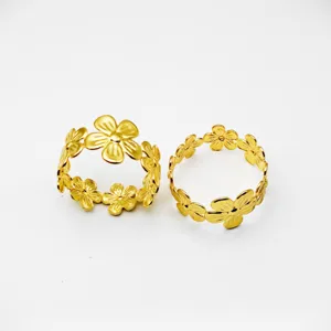 Gold metal flower napkin rings for table decor, elegant floral design wedding dinner table.