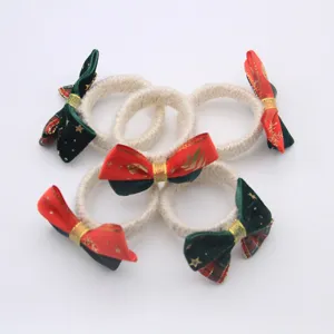 Handmade Christmas bow napkin rings, rustic hemp rope table decor for hotel and party.