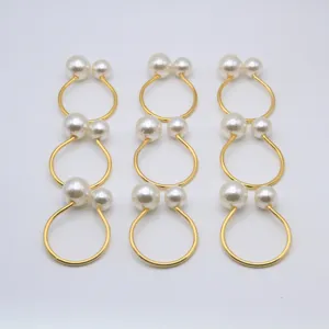 Elegant gold napkin rings featuring chic double artificial pearls for wedding and hotel table decor.