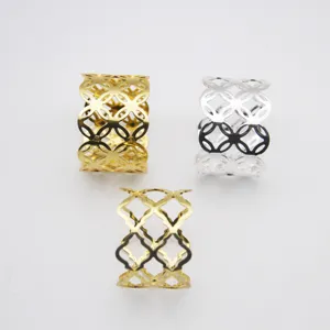 Gold and silver hollow geometric napkin rings for dining table decor and table setting.