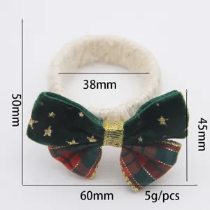 Detail view of a Christmas velvet bow napkin ring with star patterns and natural rope.