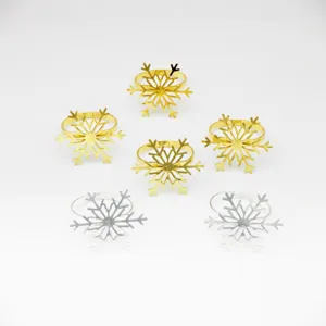 Detailed view of metal snowflake napkin rings in gold and silver finishes for festive dining.