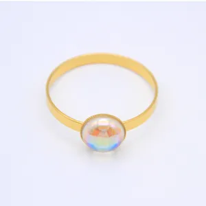 Gold metal napkin ring featuring a 20mm iridescent glass dome for table decor detail.