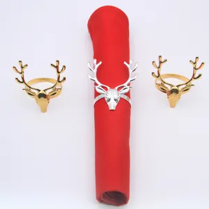 Christmas reindeer napkin rings set, metallic gold and silver deer head table decor detail.
