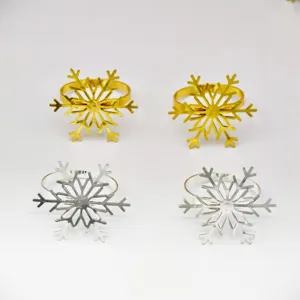 Close-up detail of silver and gold snowflake napkin rings, perfect for holiday table decor.