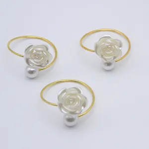 Gold metal napkin rings featuring white rose and pearl decoration set of three dining table decor