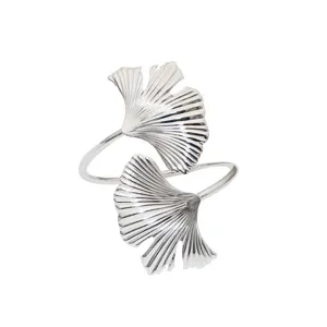 Silver metal ginkgo leaf napkin ring detail, elegant table decor for weddings and hotels.