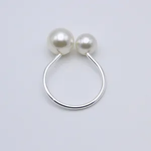 Pearl napkin ring detail shot, elegant table setting accessory for wedding hotel decor.