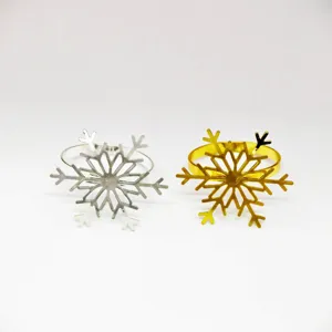 Silver and gold metal snowflake napkin rings for holiday table decor and dining settings.