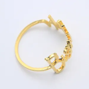 Luxury metal napkin ring with elegant English letter design, gold finish for table decor.