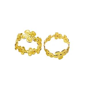 Gold metal flower napkin rings for table setting, elegant table decor and hotel accessories.