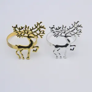 Close-up detail of gold and silver reindeer napkin rings, perfect for Christmas table decor.