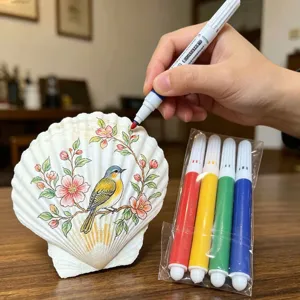 DIY schelpen schilderset met grote natuurlijke sint-jakobsschelp en vier kleurrijke markeerstiften.