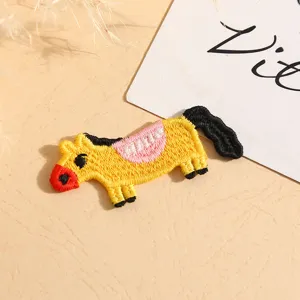 Cute cartoon pony embroidered patch detail, colorful DIY decorative accessory for clothes bags.