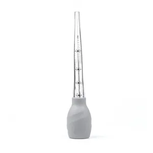 Glass tube turkey baster detail with silicone bulb and volume measurement markings.