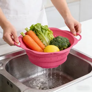 Collapsible silicone colander for kitchen, folding vegetable and fruit washing basket tool.