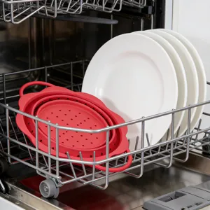 Collapsible silicone colander in red, heat-resistant draining basket for kitchen use.