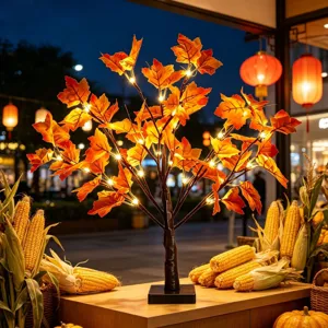 Detailed view of LED artificial maple tree light with glowing autumn leaves for party decor.