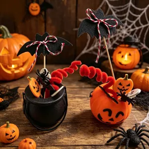 Detailed shot of Halloween pumpkin buckets and bat cake picks for party table decor.