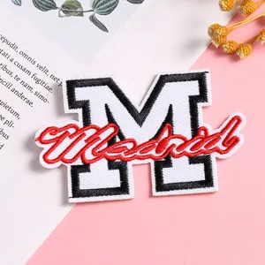 Detailed view of the creative embroidered M letter Madrid patch for DIY clothing repair.