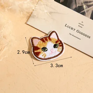 Close-up detail shot of a cute cartoon cat embroidered patch, perfect for DIY clothing decor.