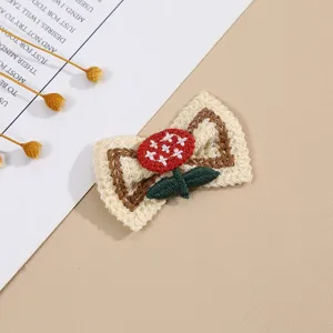 Knitted embroidered flower bow patch for clothing decoration, cute handmade DIY accessory.