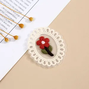 Close-up detail of white mesh lace oval embroidered flower patch, exquisite craftsmanship.